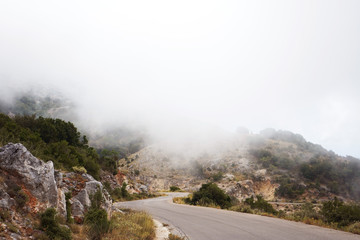 mountain road stretching into a thick white cloud, the highest point of the Greek mountains