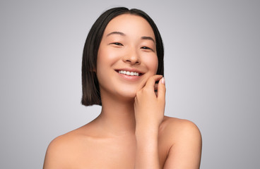 Delighted ethnic woman with clean skin