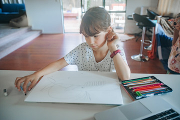 young caucasian girl drawing at home, on-line art calss, home schooling, stay home education