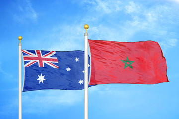 Australia and Morocco two flags on flagpoles and blue cloudy sky