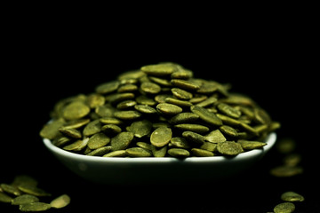 Pumpkin seeds close up , on black background