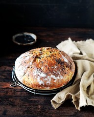 Homemade bread with black sesame seeds on a dark wooden table
