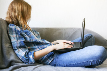 Girl in medical mask is working from home. Online freelance during the time of quarantine....