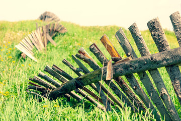 Wooden old fence in the summer field