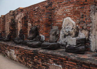 Row of the ruined and headless statuaries of Buddah