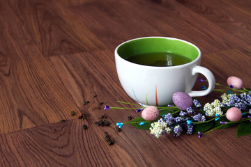 easter green tea in a mug on a dark background
