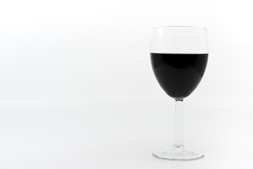 Glass of red wine on a plain white background with space for copy