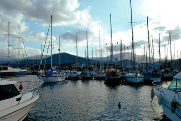 Giant yachts at pier in small harbor of old European city. Summer travel concept