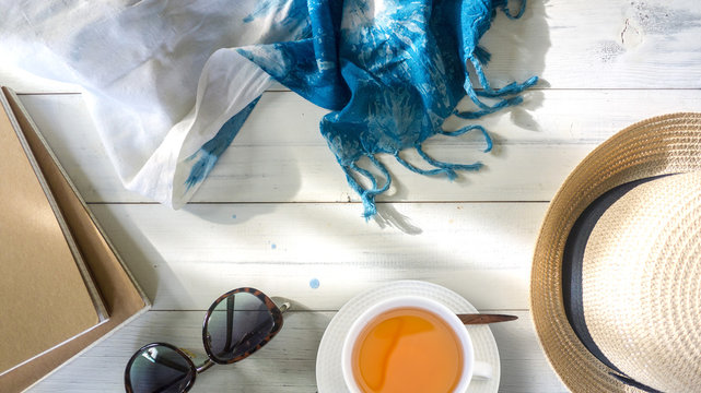 summer tme concept. Cup of tea on white wooden background