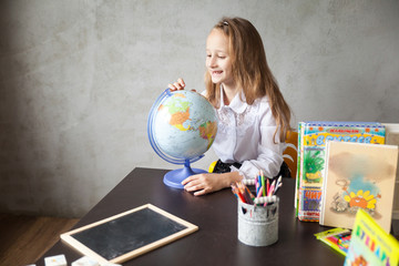 School girl in a uniform studying from home. back to school concept