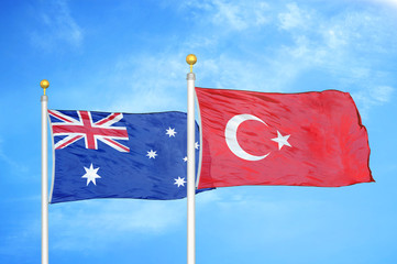 Australia and Turkey two flags on flagpoles and blue cloudy sky