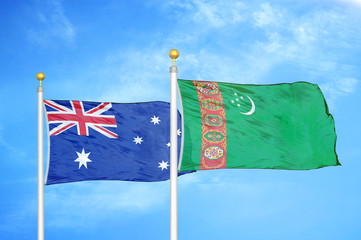 Australia and Turkmenistan two flags on flagpoles and blue cloudy sky