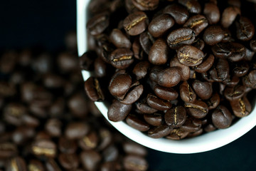 Coffee beans in a white cup , close up , top view
