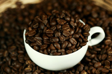 Coffee beans in a white cup , close up , top view