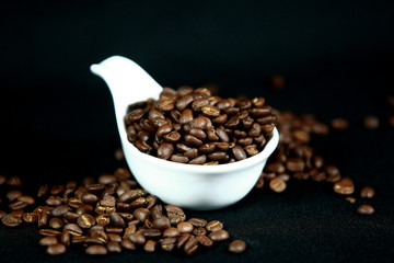 Coffee beans in a white cup , close up , top view