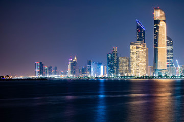 Beautiful City night view of Abu Dhabi financial and commercial district, taken during blue hour,...