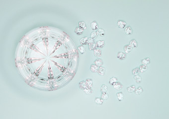 Glass and cracked ice on mint background