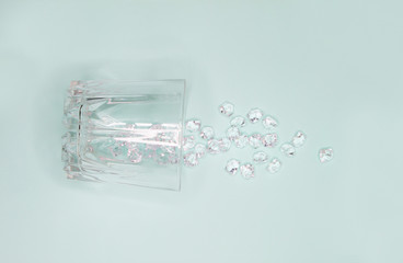 Glass and cracked ice on mint background