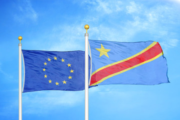 European Union and Congo Democratic Republic two flags on flagpoles and blue cloudy sky