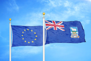 Fototapeta premium European Union and Falkland Islands two flags on flagpoles and blue cloudy sky