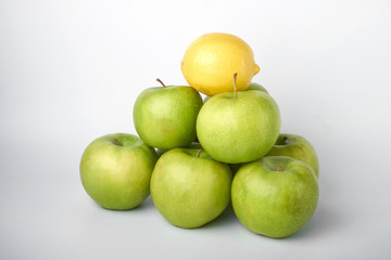 Perfect fresh green Apple with lemon isolated on a white background in full depth of field with a cropped trajectory.