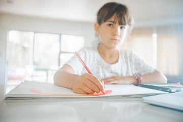 young caucasian girl drawing at home, on-line art calss, home schooling, stay home education