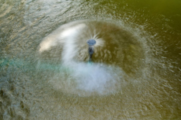 Circle spread water of fountain in the pond