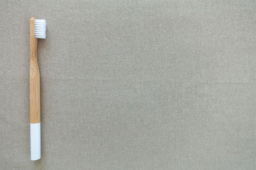 Bamboo toothbrush, environmental friendly and minimal lifestyle, on a copy space background.
