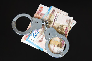 Money and handcuffs. Criminal punishment for a bribe