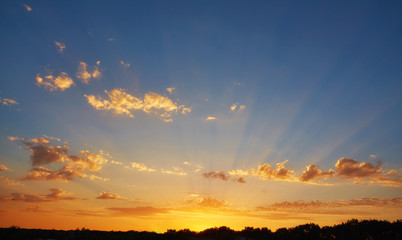 Fototapeta na wymiar Sunset sunrise with clouds, light rays