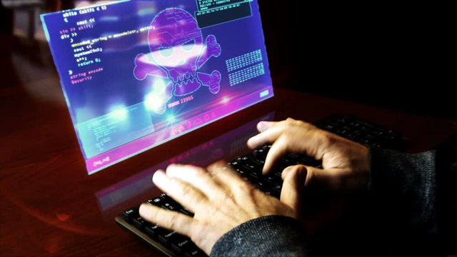 The hacker typing on the keyboard and breaks computer security on virtual hologram screen on desk. Cyber attack, cybercrime, piracy, digital safety and identity theft concept. Hand shake camera.