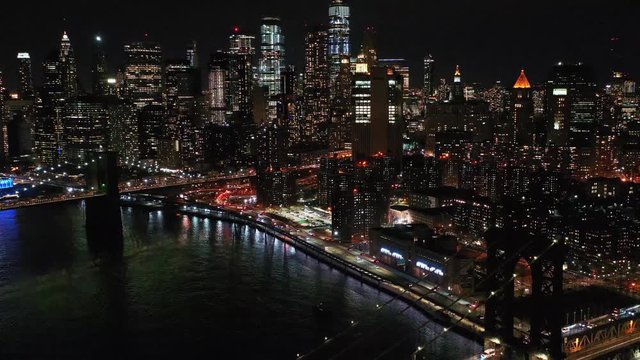 New York City, Brooklyn Bridge. Flying over New York City at night.