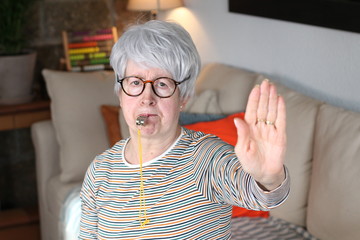 Senior woman blowing a whistle