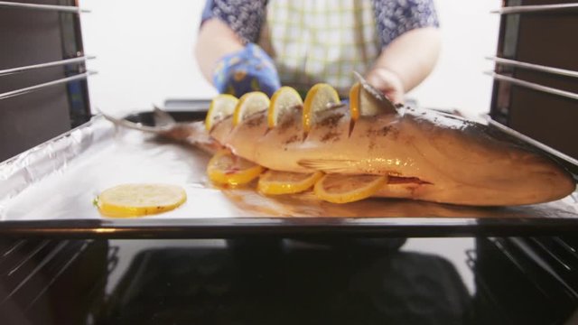 Cooking whole roasted fish seriola amberjack baked in the oven.