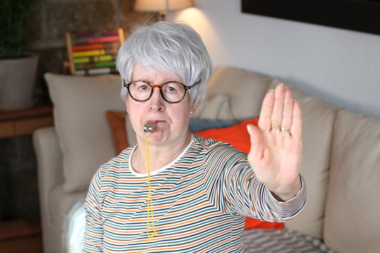 Senior Woman Blowing A Whistle