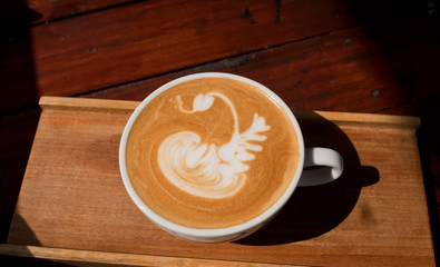 hot latte art coffee on wood table, relax time
