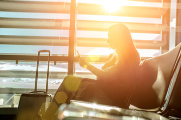 Woman waiting aircraft in airport. Young Female tourist travelin
