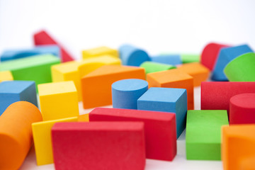Background of colorful toy figures. Children's blocks on a white background