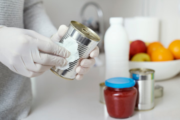 man disinfecting the purchases