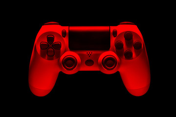 White video game joystick gamepad in red neon lights isolated on a black