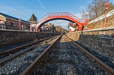 Fototapeta na wymiar Train tracks at an old station platform