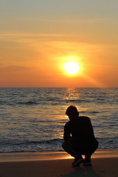 Young man capturing sunset with smartphone. Shot at kappil Beach, Trivandrum.
