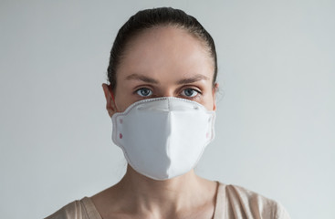 A young woman in medical mask on her face.
