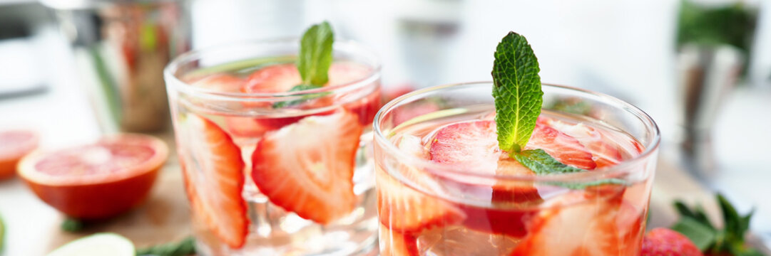 Glasses with alcoholic cocktails stand on table