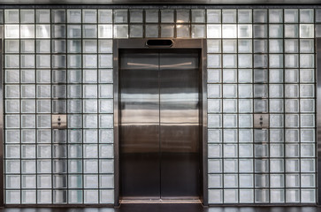 Elevator doors in a glass wall