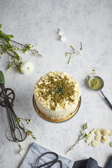 White chocolate frosted layer cake with pistachios and macha