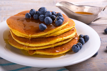 mouth-watering pancakes with blueberries, blackberries and maple syrup
