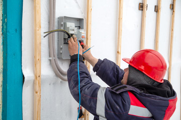Electrical Worker Repairing Electrical Board