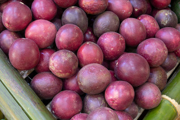 Closeup for passion fruits (Passiflora edulis) in basket made from bamboo.