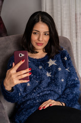 Young woman is taking selfie from home during quarantine time at coronavirus.